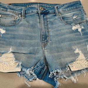 American Eagle Jean ripped shorts with crochet white pocket detail.